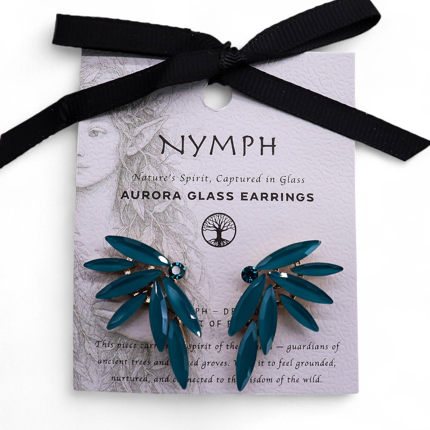 Delicate teal-green fairy wing earrings with translucent vintage glass, glowing softly against moss and forest leaves