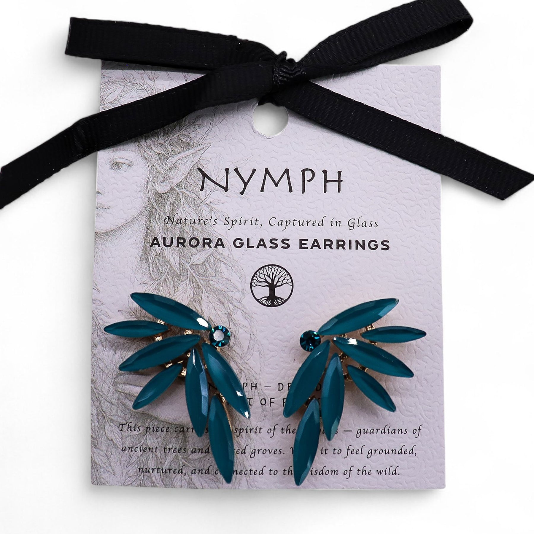 Delicate teal-green fairy wing earrings with translucent vintage glass, glowing softly against moss and forest leaves