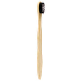 Single bamboo toothbrush with charcoal-infused medium-soft bristles, natural bamboo handle