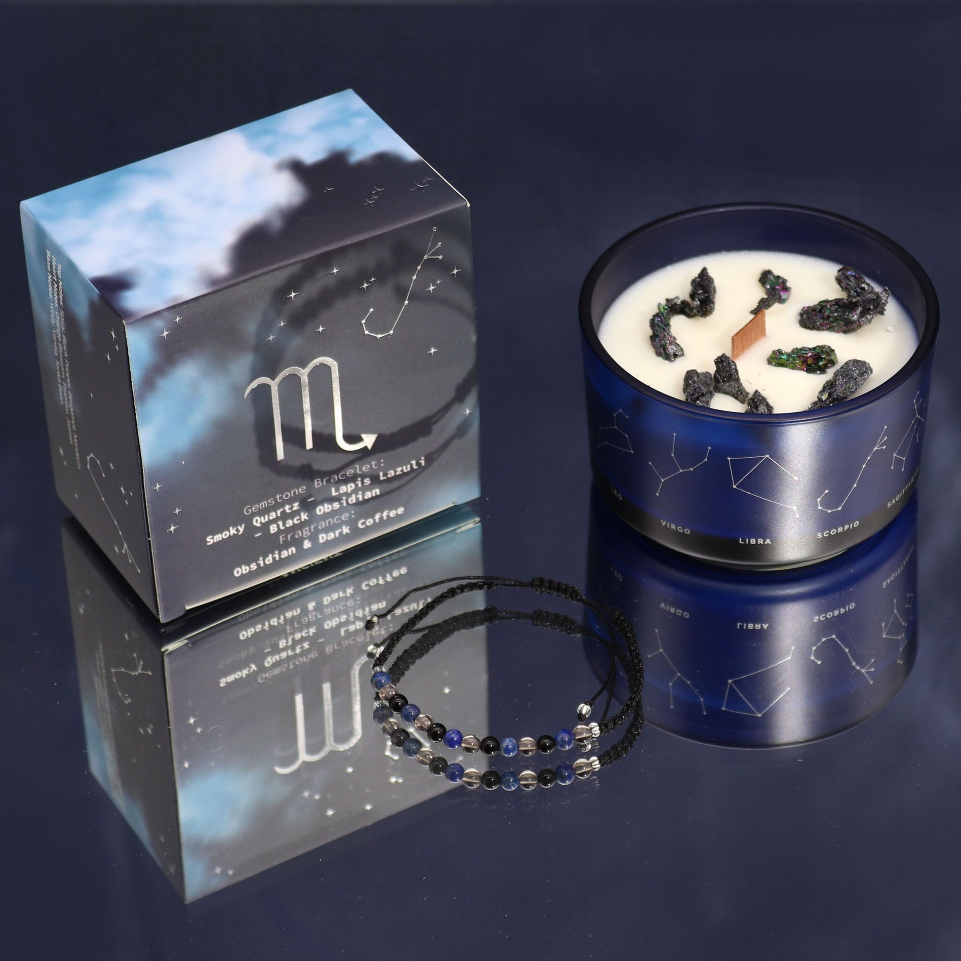 Candle with Scorpio symbol packaging and beaded necklace on a dark background