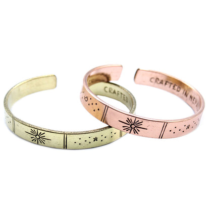 Hand-hammered brass galaxy cuff from Nepal with secret inner mantra (Dream Big, Reach For The Stars & more). Stars & Earth design outside. Fair-trade, adjustable, gift-ready with story card