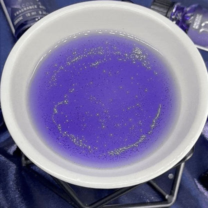 Purple liquid in a white bowl with a blue background