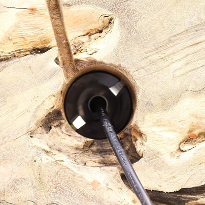 Black cable with a plug inserted into a wooden socket