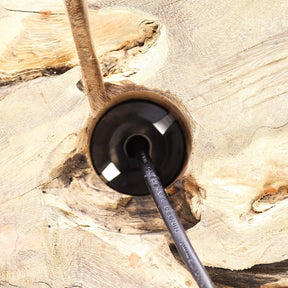 Black cable with a plug inserted into a wooden socket