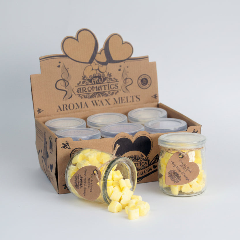 Aroma wax melts in jars with a cardboard box labeled 'Aromatics Aroma Wax Melts' on a light gray background.