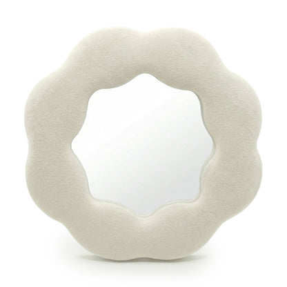 Soft squiggly mirror in neutral stone-toned velvet frame shaped like a gentle flower silhouette with wavy edges