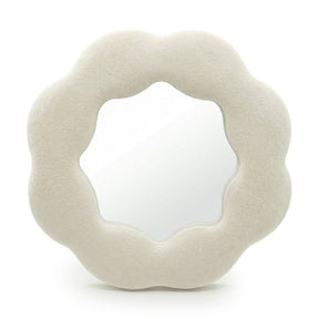 Soft squiggly mirror in neutral stone-toned velvet frame shaped like a gentle flower silhouette with wavy edges
