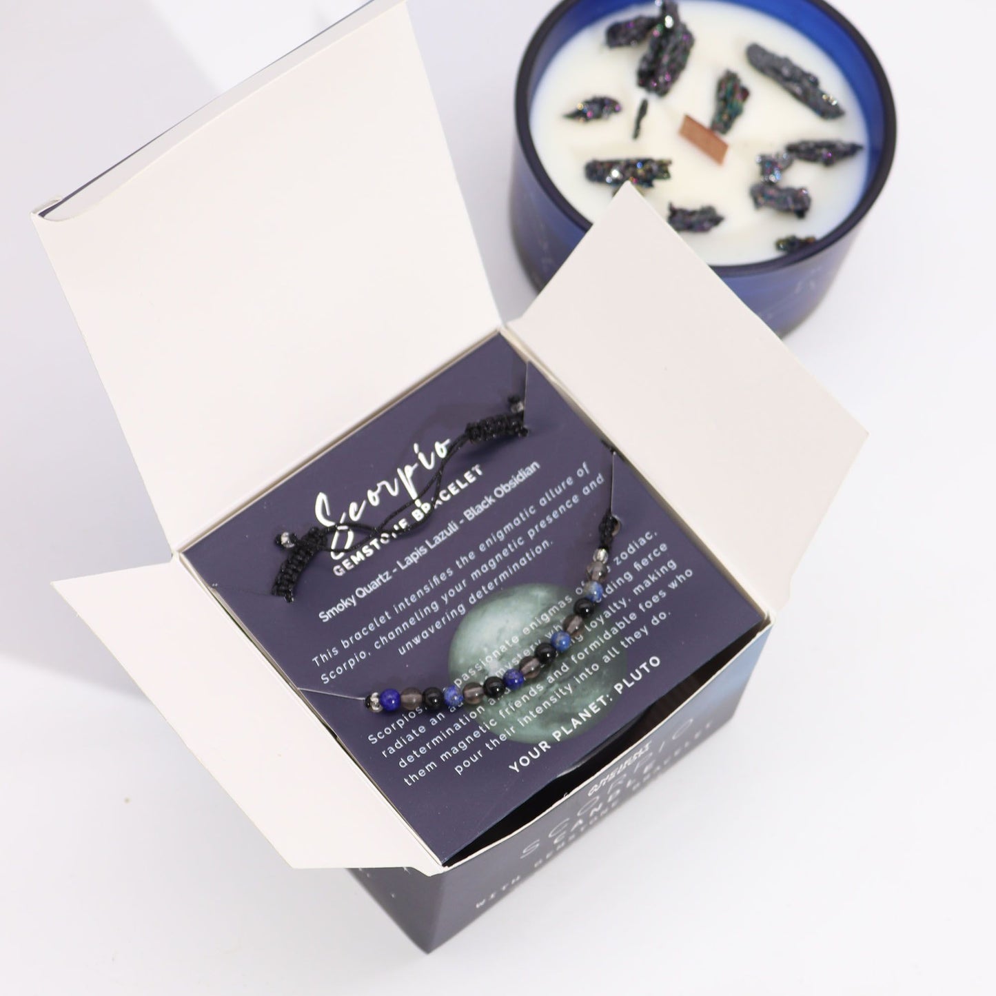 Scorpio zodiac bracelet with packaging and candle on a white background
