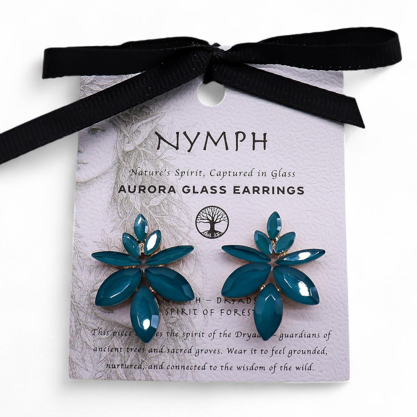 Teal green vintage glass flower earrings glowing like fresh spring leaves, styled on white linen with moss and tiny forest flowers