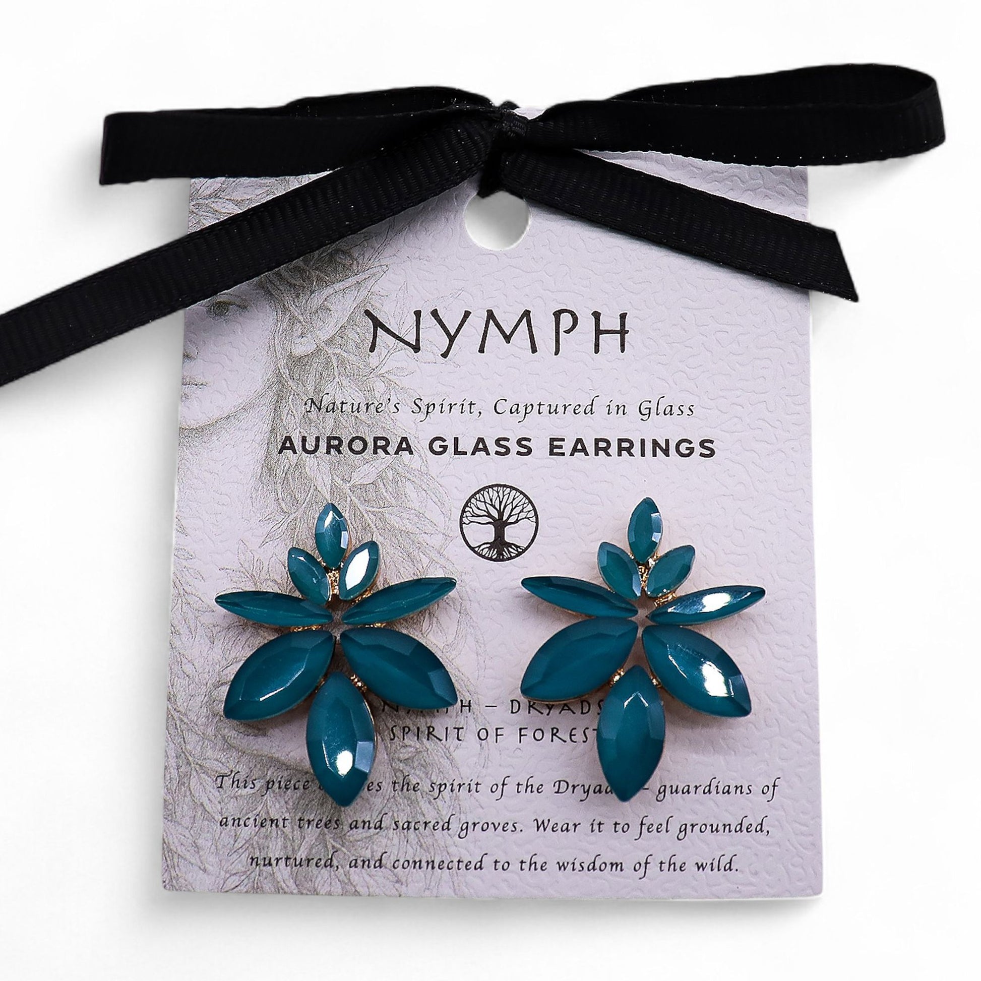 Teal green vintage glass flower earrings glowing like fresh spring leaves, styled on white linen with moss and tiny forest flowers