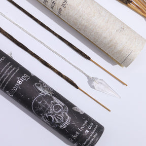 Incense sticks with packaging and pendulum on a white background
