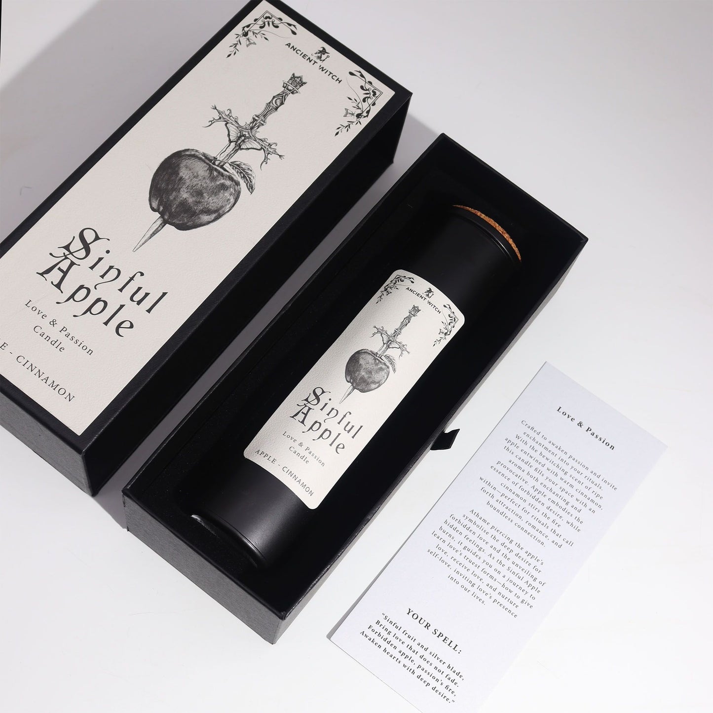 Candle labeled 'Sinful Apple' in a decorative box with a white background
