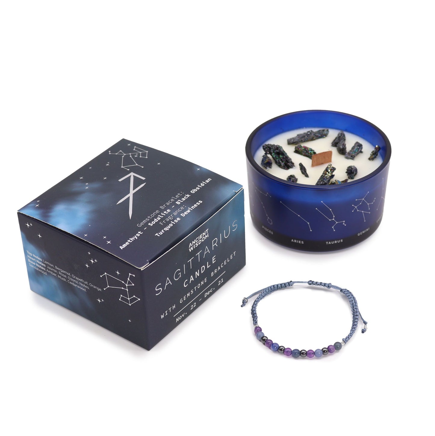 Sagittarius candle with decorative stones, packaging, and bracelet on a white background