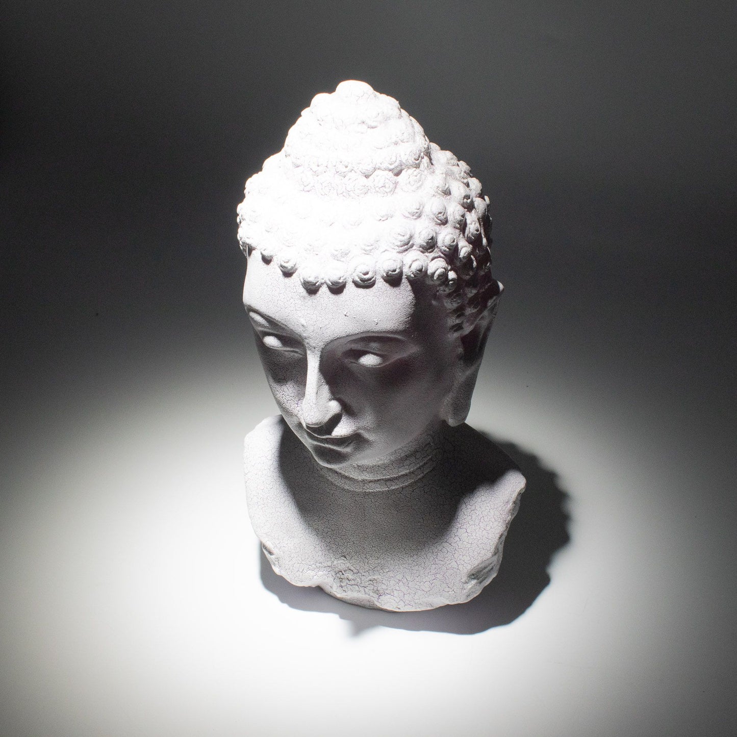 Buddha Bust Lamp with crackle textured surface on modern oval stand