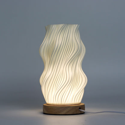 Close-up of lamp’s textured honeycomb pattern and soft diffused light, showing elegant star-like twisted shape and wooden base detail