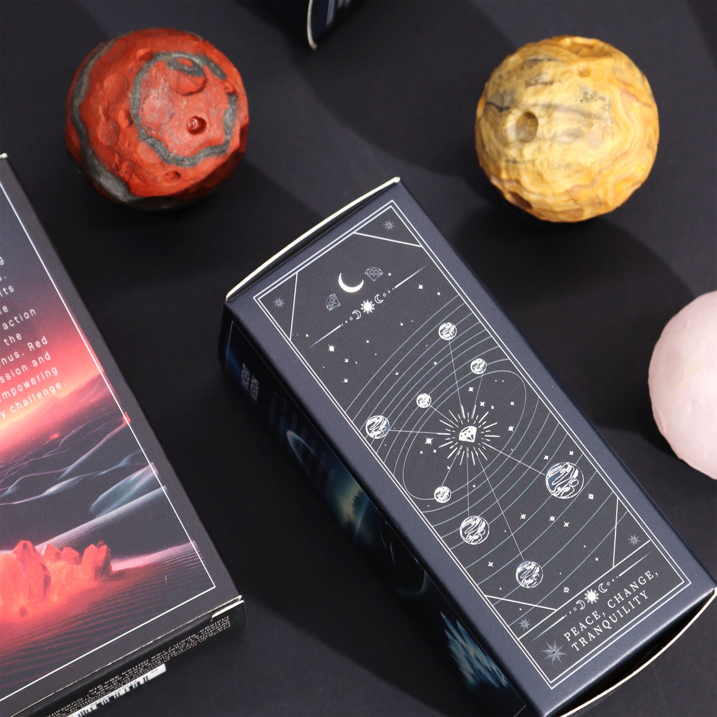 40mm swirling Crazy Lace Jasper Mercury sphere floating on shimmering goldstone ring stand, glowing against starry cosmic background