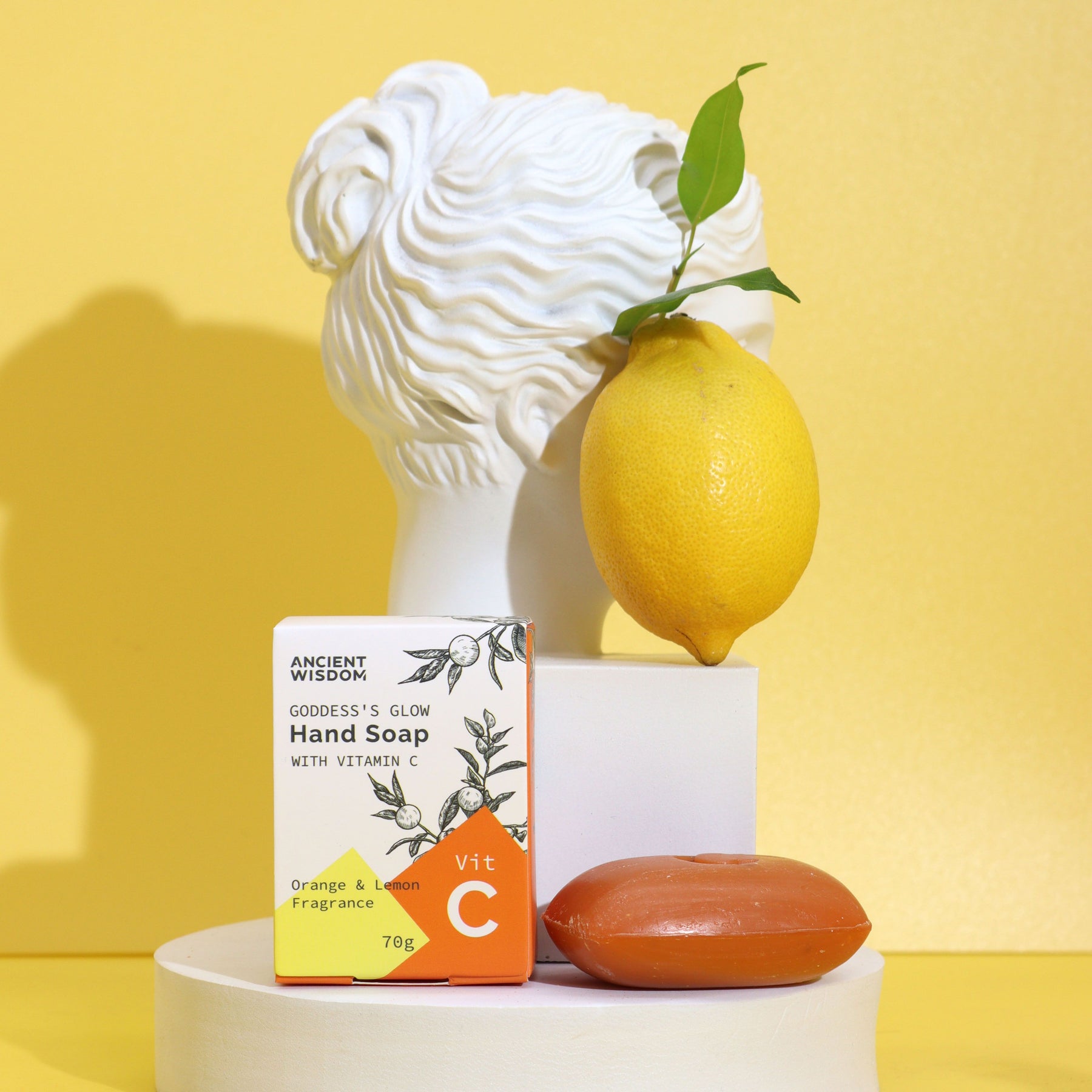 Hand soap packaging with a lemon and decorative head on a yellow background