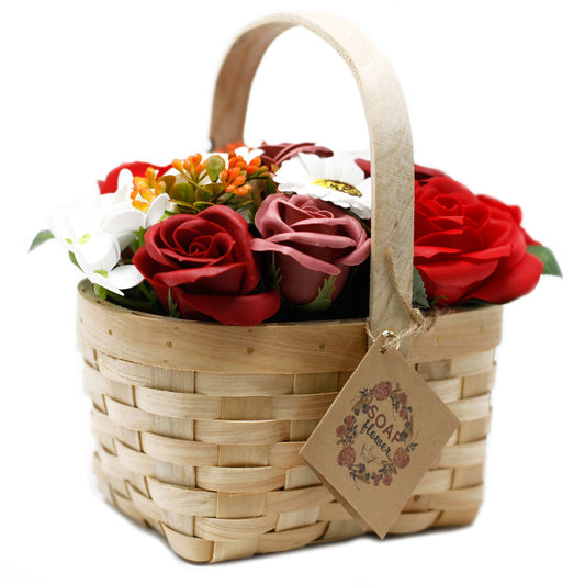 Large red soap flower bouquet with lifelike roses and blooms beautifully arranged in natural wicker basket, tied with ribbon, presented as luxury bath gift on soft white background
