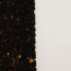 Close-up of black tea leaves on a white background