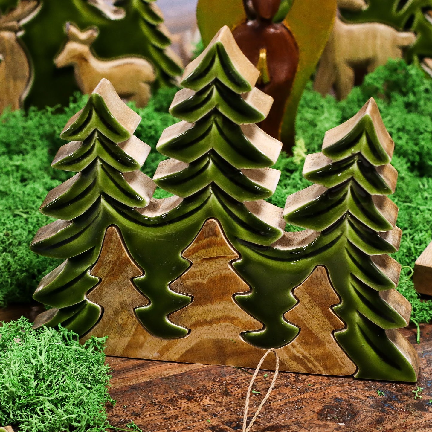 20×23cm 3D mango wood three pine trees decoration with deep green enamel branches on wooden base, styled on winter mantel with fairy lights and snow