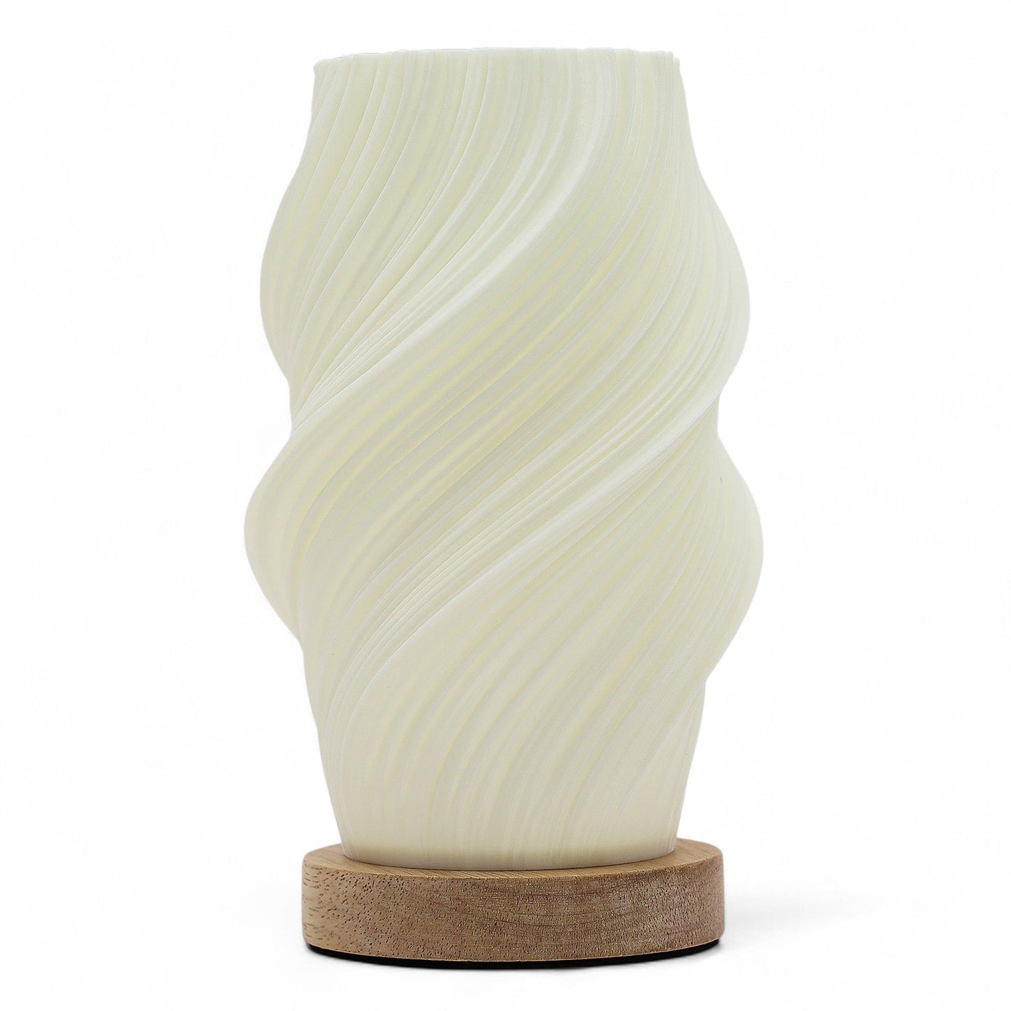 Cloud Twisted New Wave USB lamp with textured honeycomb surface and soft cloud-inspired twisted shape, warm glow on 3rd brightness setting, placed on wooden base