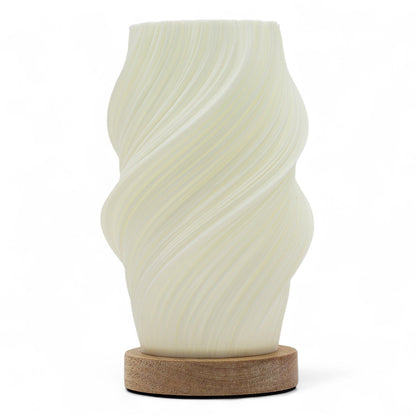 Cloud Twisted New Wave USB lamp with textured honeycomb surface and soft cloud-inspired twisted shape, warm glow on 3rd brightness setting, placed on wooden base
