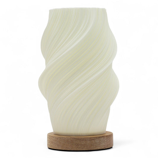Cloud Twisted New Wave USB lamp with textured honeycomb surface and soft cloud-inspired twisted shape, warm glow on 3rd brightness setting, placed on wooden base