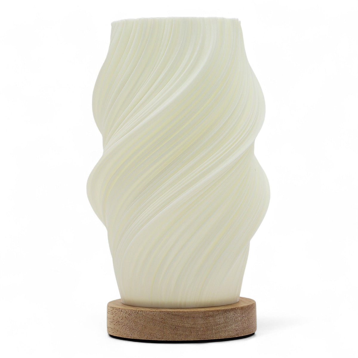 Cloud Twisted New Wave USB lamp with textured honeycomb surface and soft cloud-inspired twisted shape, warm glow on 3rd brightness setting, placed on wooden base