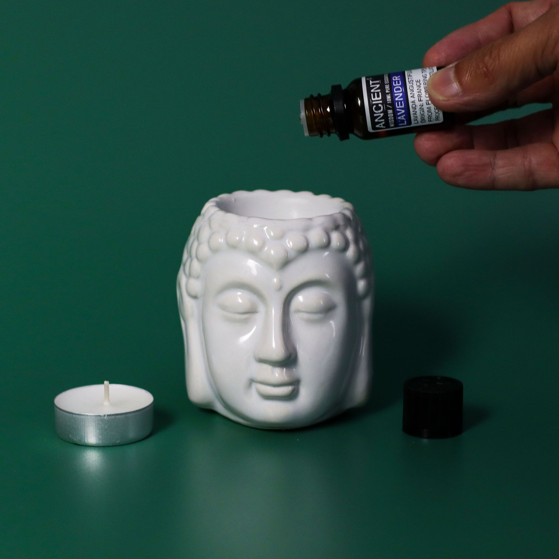 10ml amber glass bottle of pure Lavender Essential Oil with black dropper cap, fresh lavender sprigs