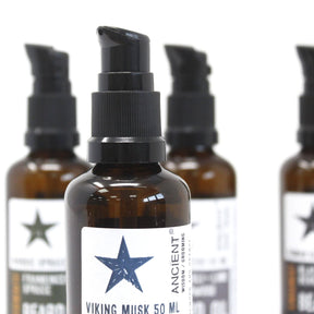 Bottle of Viking Musk 50 ML with star design on label, surrounded by similar bottles.
