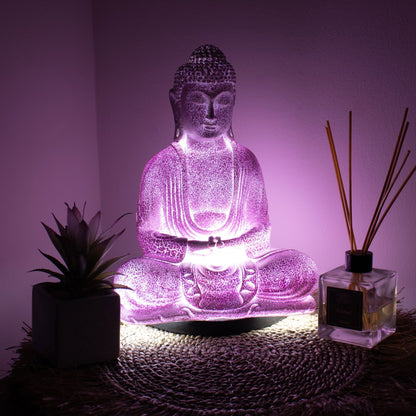 Meditation Buddha Lamp with crackle textured surface on modern oval stand, emitting soft warm ambient glow in a calm living space with subtle lighting