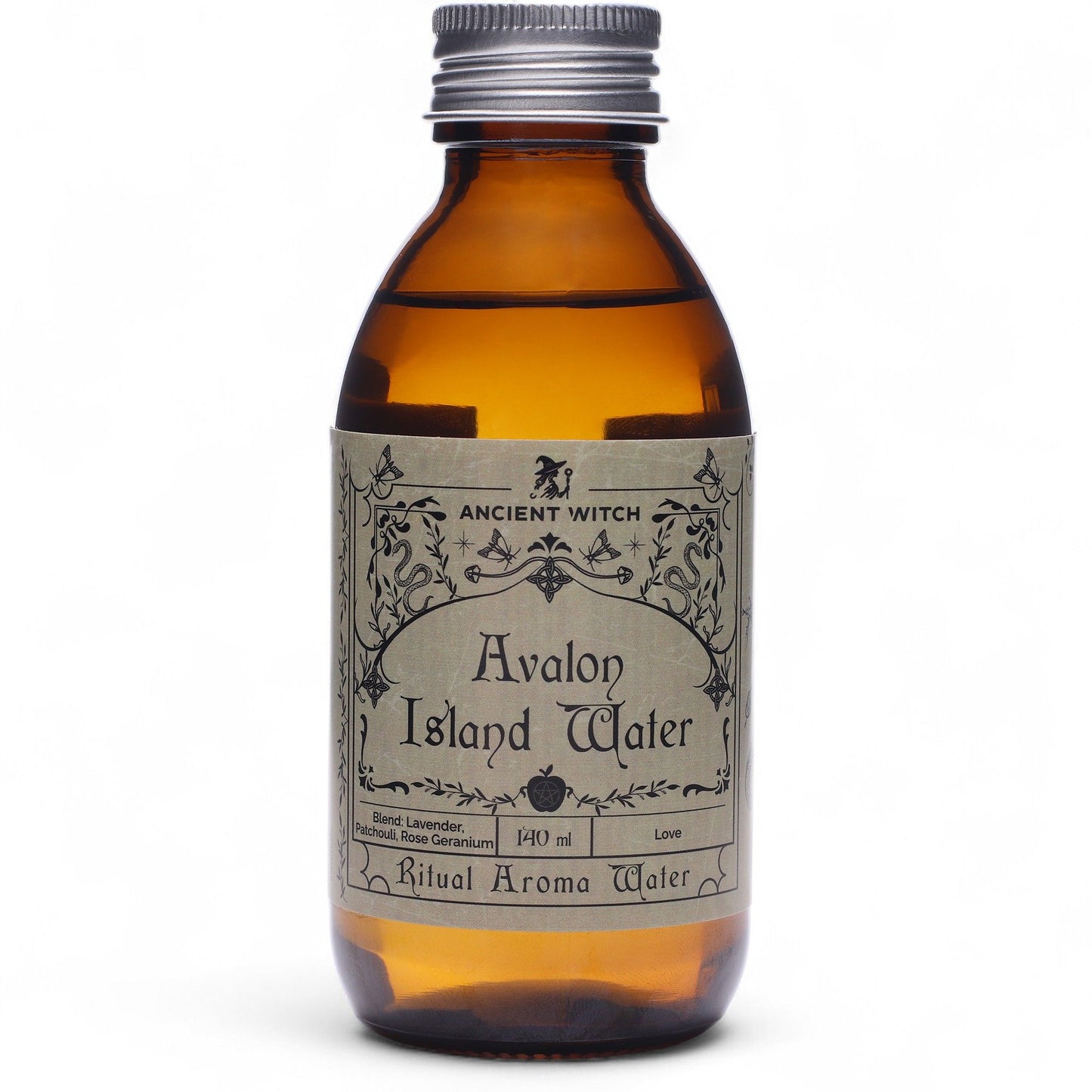 140ml amber bottle of Avalon Island ritual water with misty isle & nine priestesses label, surrounded by fresh lavender, roses and glowing candles