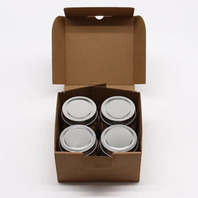 Four metal cans in a brown cardboard box on a white background