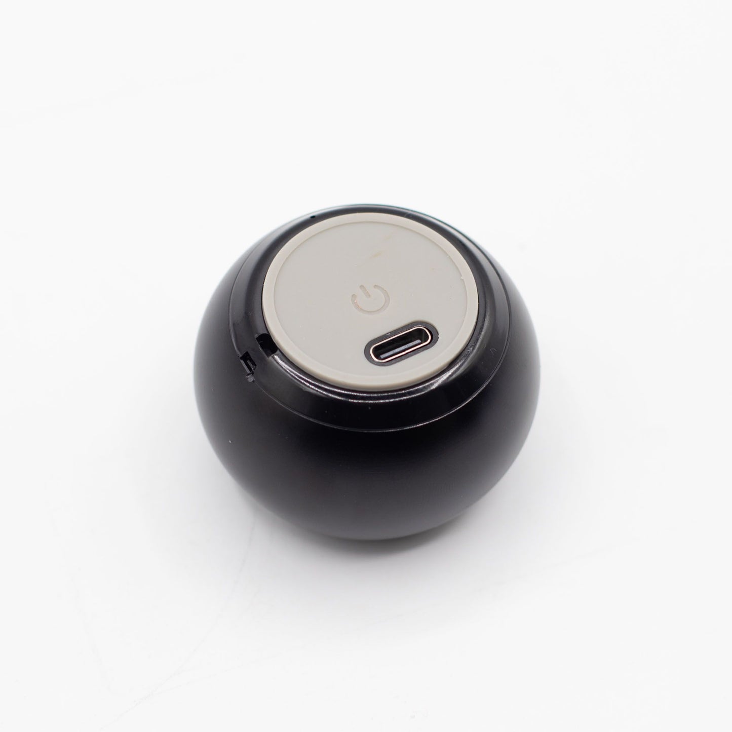 Speaker connected via USB charging cable, 300mAh battery indicator lit, compact size