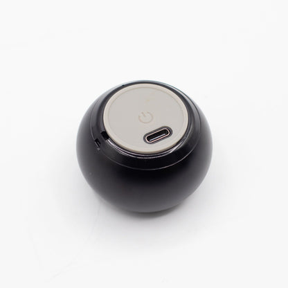 Speaker connected via USB charging cable, 300mAh battery indicator lit, compact size