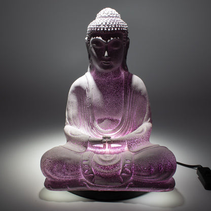 Meditation Buddha Lamp with crackle textured surface on modern oval stand, emitting soft warm ambient glow in a calm living space with subtle lighting