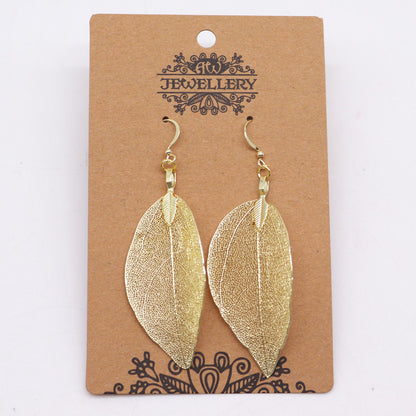 Gold leaf-shaped earrings on a 'Jewellery' branded card.