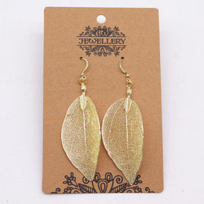 Gold leaf-shaped earrings on a 'Jewellery' branded card.
