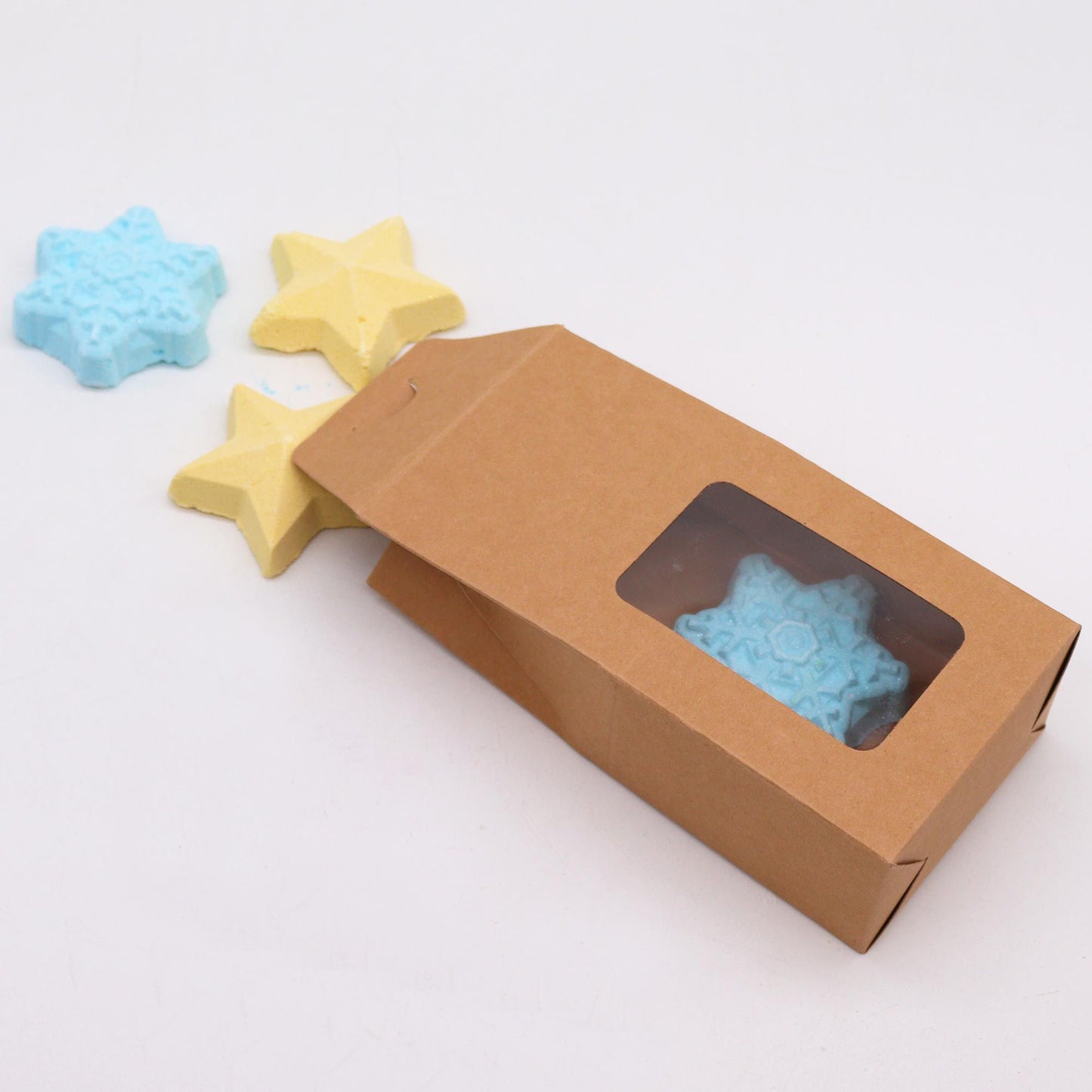 Follow the Star Christmas bath bomb gift pack with white snowflake and gold star bath bombs in kraft box with gold ribbon and starry background