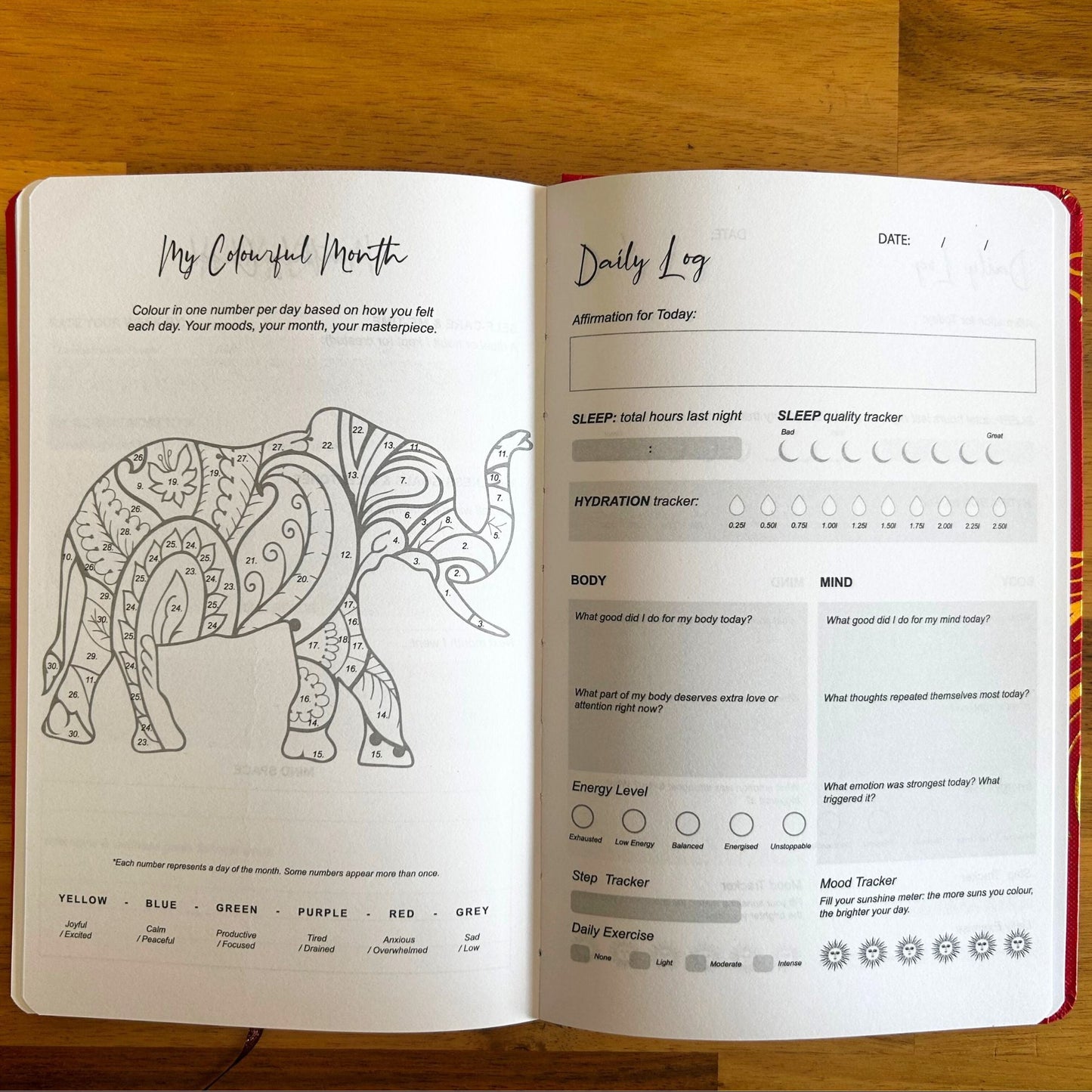 Elegant white wellness journal with rose gold foil Tree of Life, open to mood tracker and affirmation pages, styled with crystals, rose quartz and candle