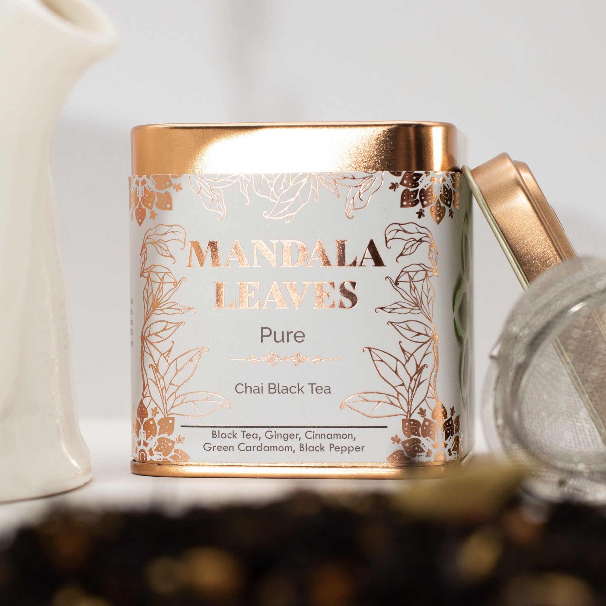 Mandala Leaves tea canister with decorative label on a blurred background