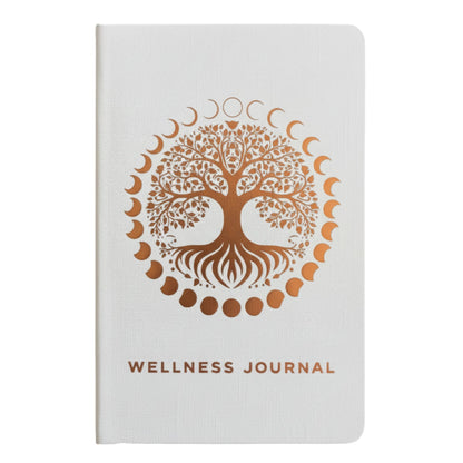 Elegant white wellness journal with rose gold foil Tree of Life, open to mood tracker and affirmation pages, styled with crystals, rose quartz and candle