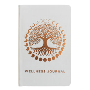 Elegant white wellness journal with rose gold foil Tree of Life, open to mood tracker and affirmation pages, styled with crystals, rose quartz and candle