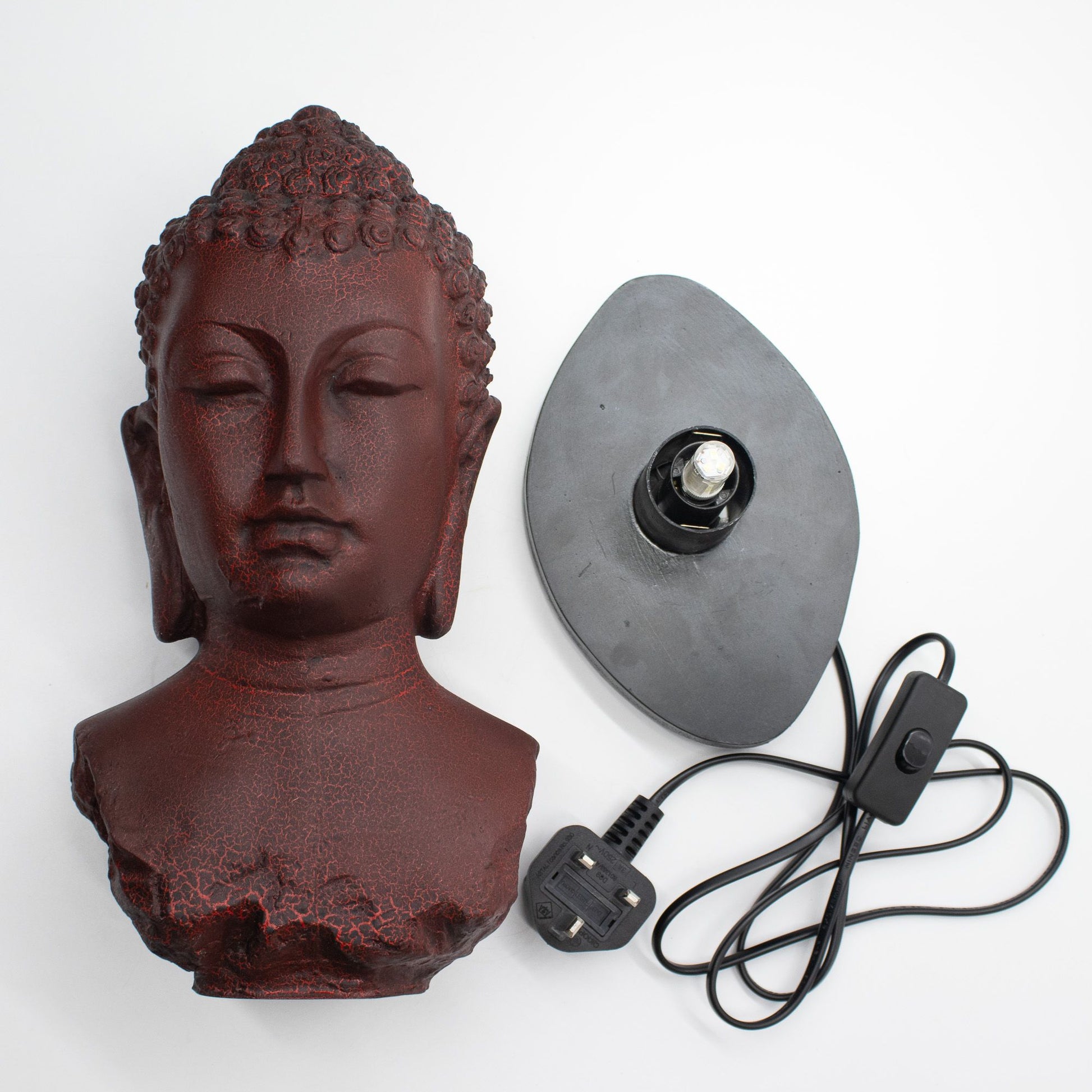 Buddha Bust Lamp with crackle textured surface on modern oval stand with cord on a white background