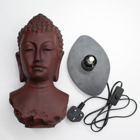 Buddha Bust Lamp with crackle textured surface on modern oval stand with cord on a white background