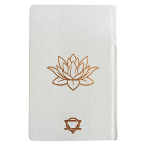 Elegant white wellness journal with rose gold foil Tree of Life, open to mood tracker and affirmation pages, styled with crystals, rose quartz and candle