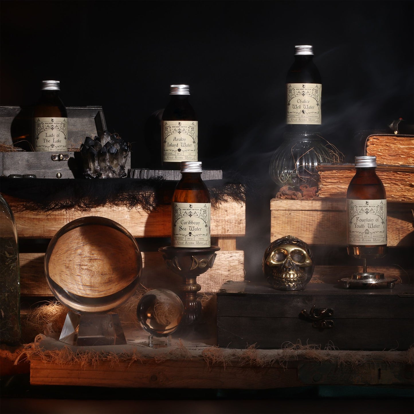 140ml amber bottle of Avalon Island ritual water with misty isle & nine priestesses label, surrounded by fresh lavender, roses and glowing candles