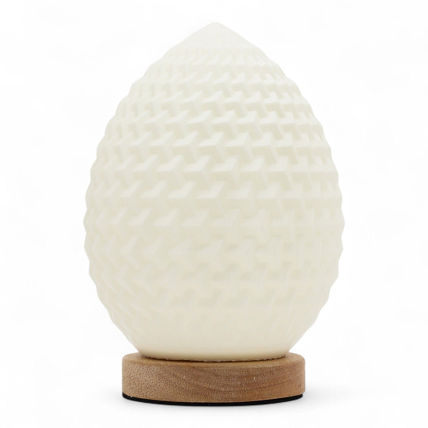 Teardrop New Wave USB lamp with textured honeycomb surface, warm glow on 3rd brightness setting, placed on wooden base