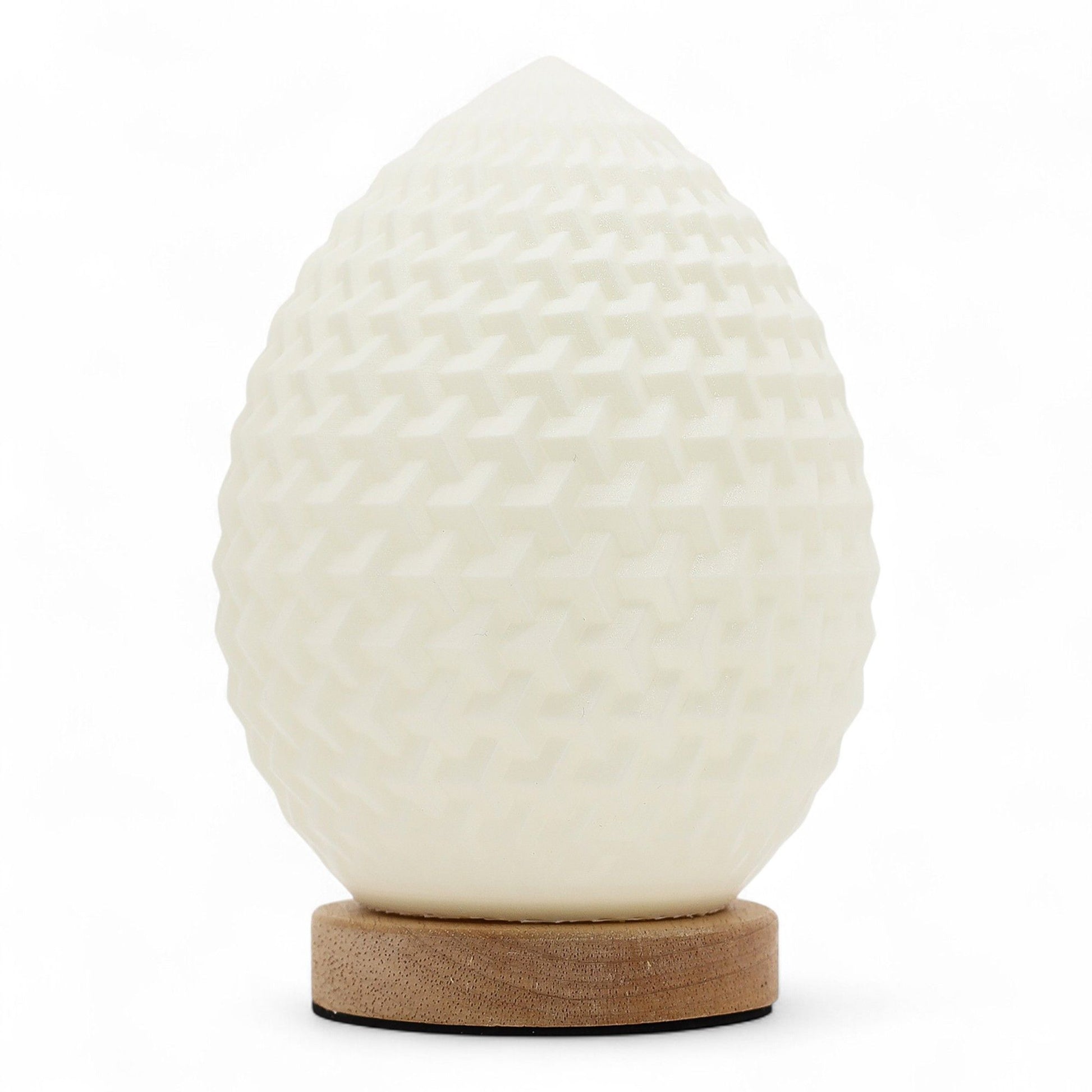 Teardrop New Wave USB lamp with textured honeycomb surface, warm glow on 3rd brightness setting, placed on wooden base
