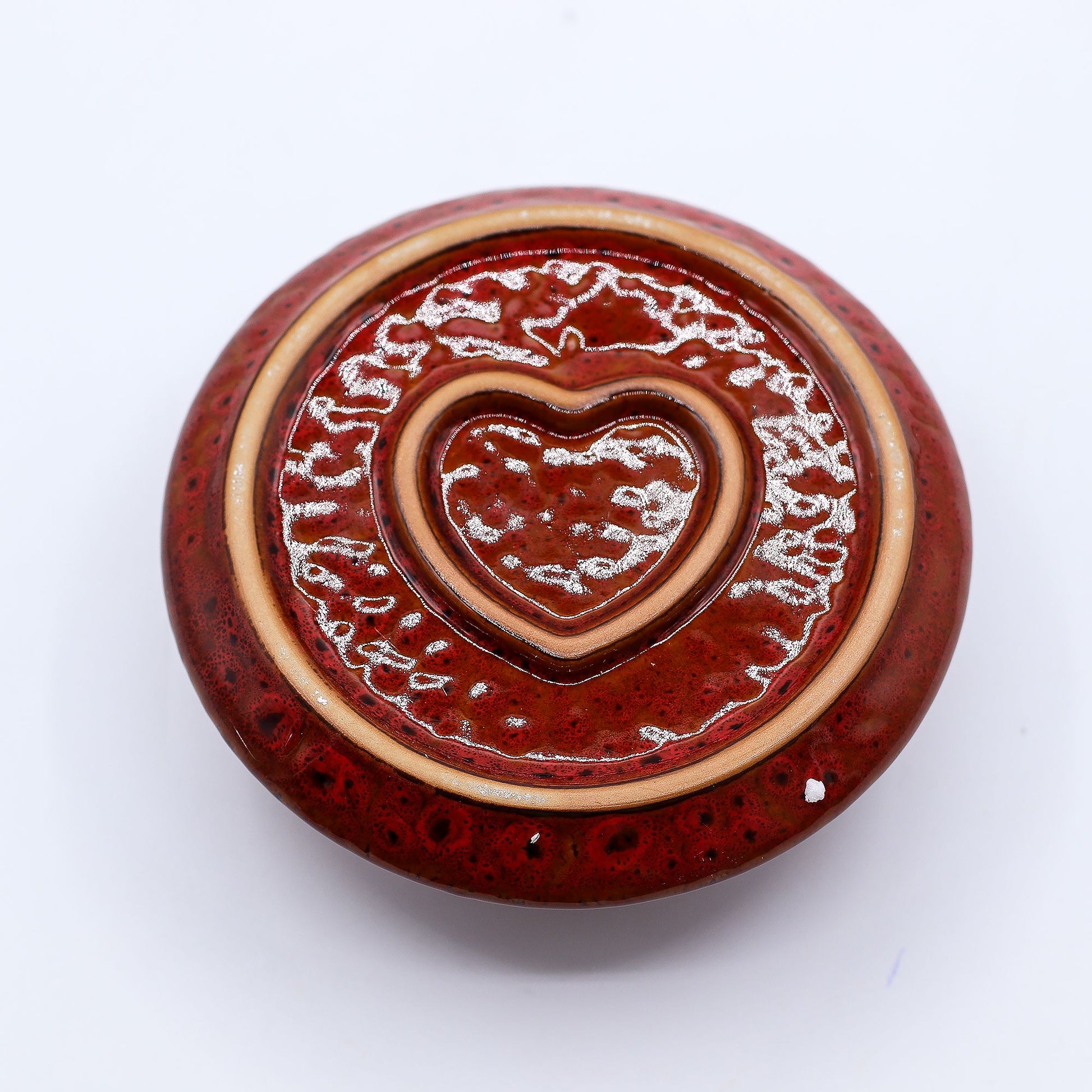Bottom of ceramic incense holder with heart design